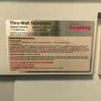 Close-up of the Doughboy Thru-Wall Skimmers operating instructions and warning label