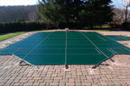 Green Pool Cover anchored to the ground on a sunny day